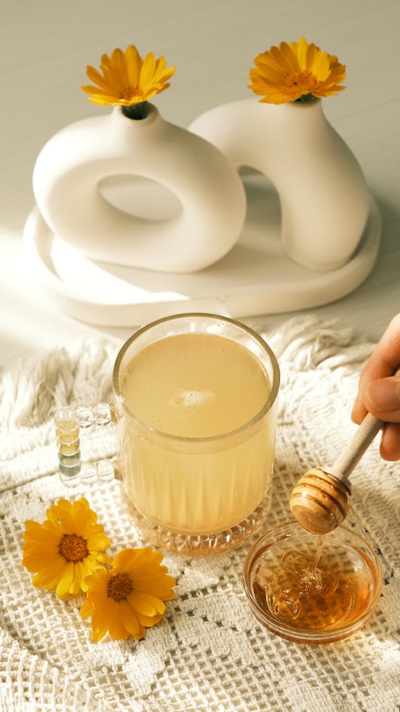 A soothing cup of lemon honey tea with beautiful yellow flowers and modern decor.